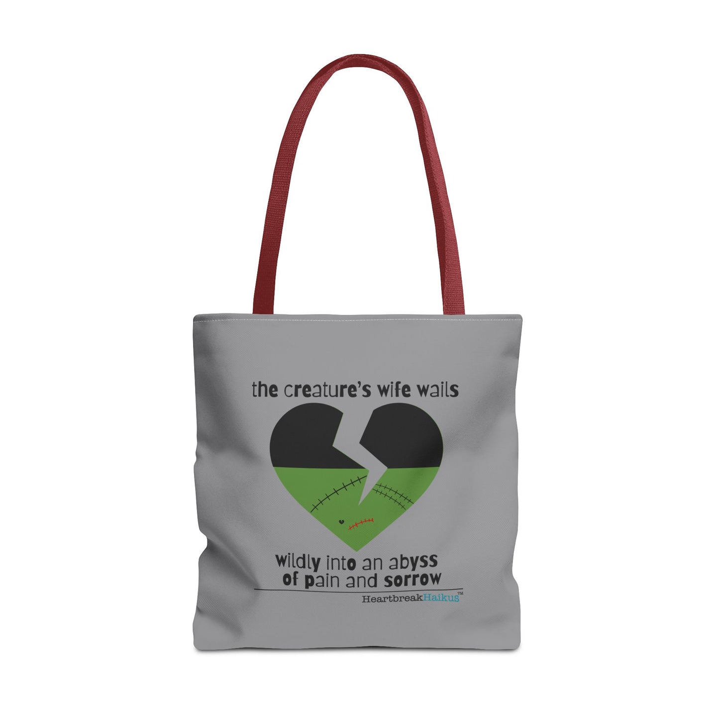 Frankenstein haiku tote bag featuring a heart design with text expressing sorrow and pain, stone grey tote with red handles.
